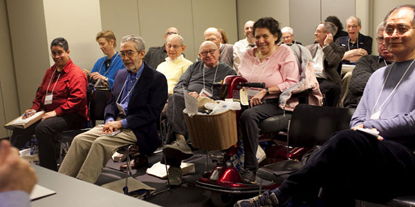 Disability - Conference audience with person using mobility scooter. Photo Credit SAGE