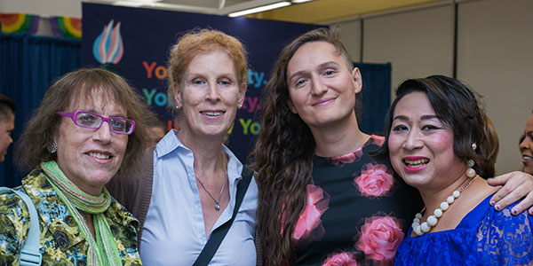 LGBT Community - Four people embracing at LGBT community event. Photo Credit SAGE